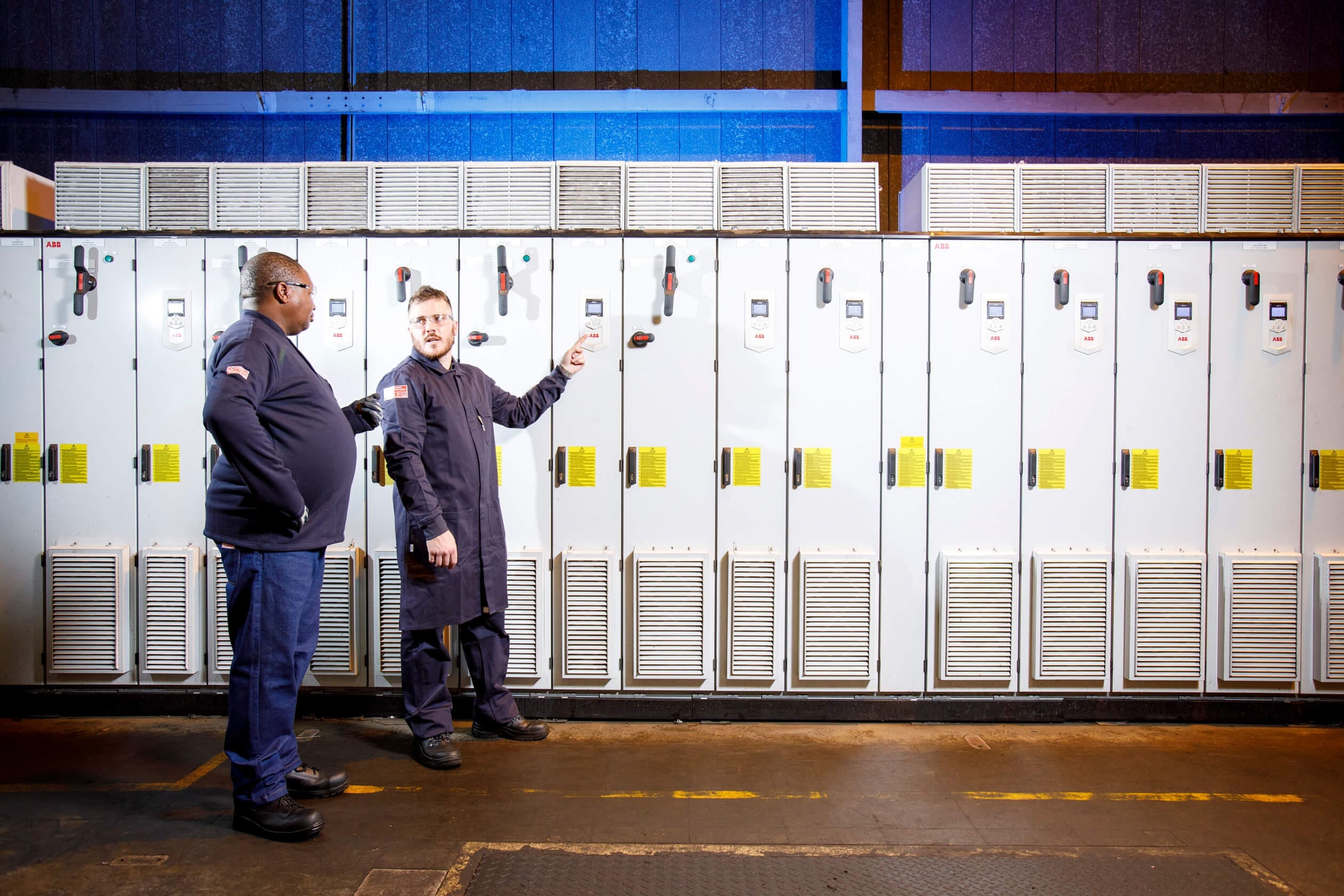 two men standing wearing SURVIVE-ARC® dust coats